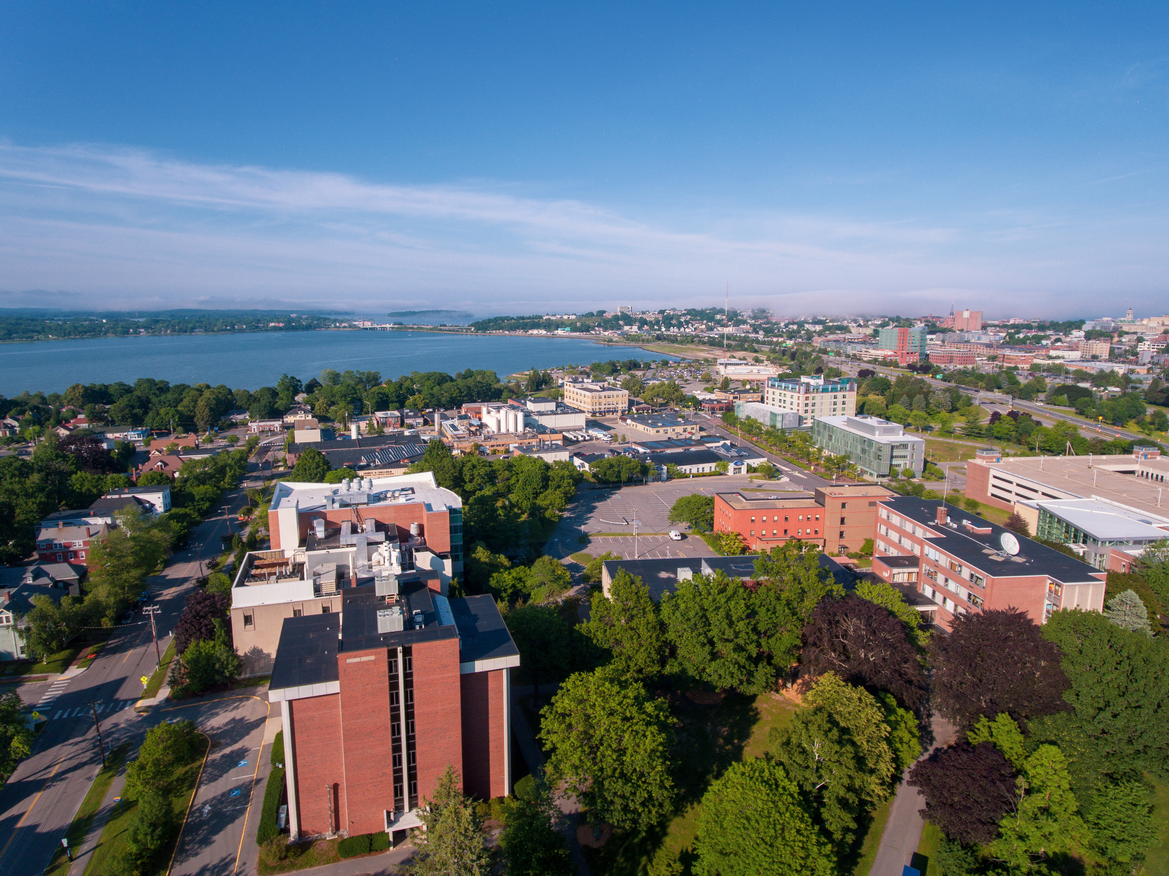 An aerial image of the Unversity of Southern Maine's Portland campus. The image shows various buildings such as the Science Building, Luther Bonney, and Masterton. The Back Cove can be seen in the background.